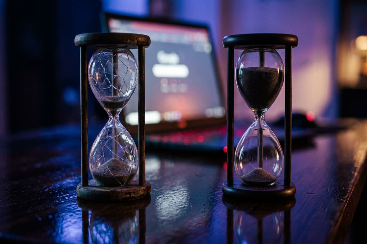 Two contrasting hourglasses representing rushed and stalled website project timelines