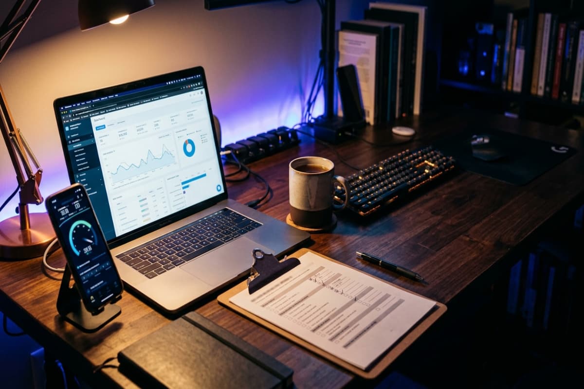 Desk set up for a technical SEO audit with laptop dashboard, checklist and mobile speed test