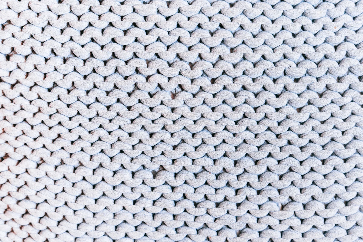 Close-up of the texture of white knitted fabric