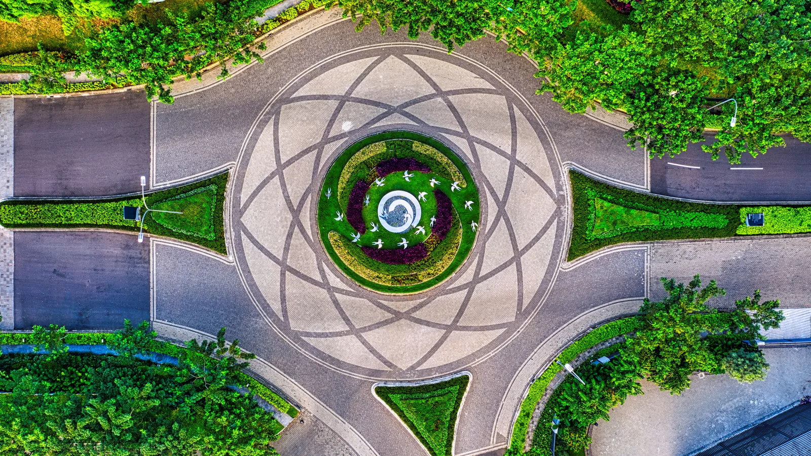 Aerial view of a circular road around a landscaped roundabout